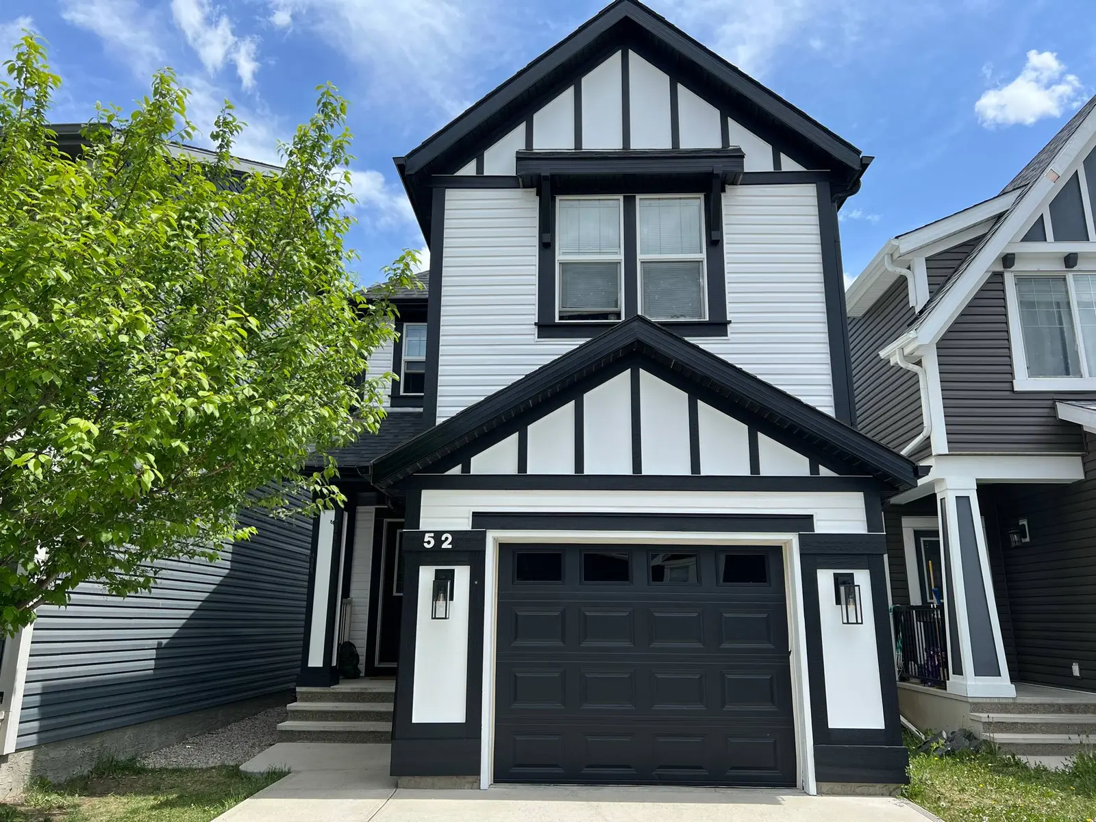 Black and white Calgary home exterior professionally painted by Dynamic Painting