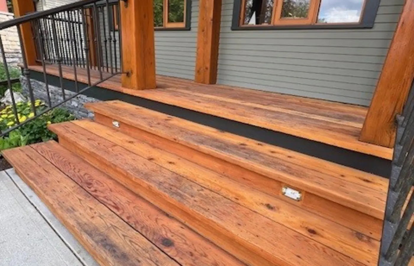 Professionally refinished cedar porch and wood steps by Dynamic Painting in Calgary