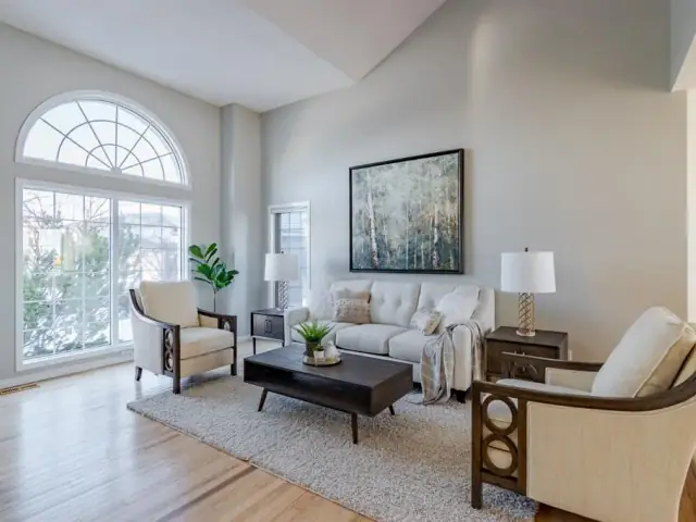 Bright staged Calgary living room with professionally painted walls and crisp white trim