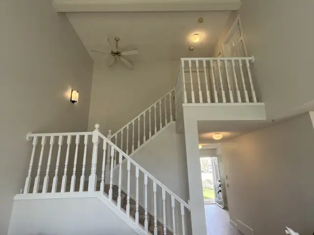 Bright painted Calgary staircase with crisp white railing and neutral walls