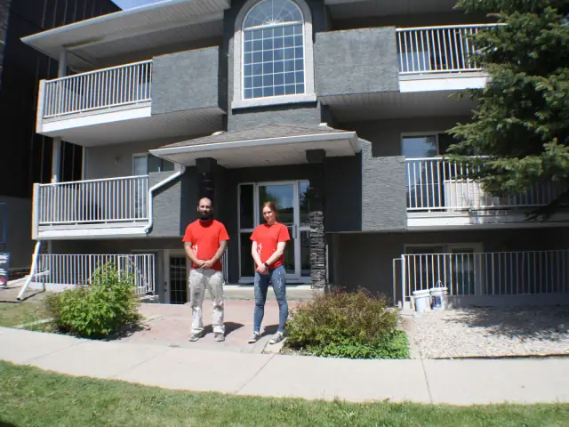 Dynamic Painting crew in front of a completed multi-unit stucco exterior painting project