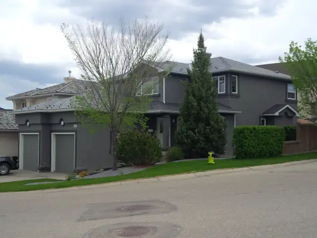 Large stucco home after a dramatic charcoal grey exterior painting transformation