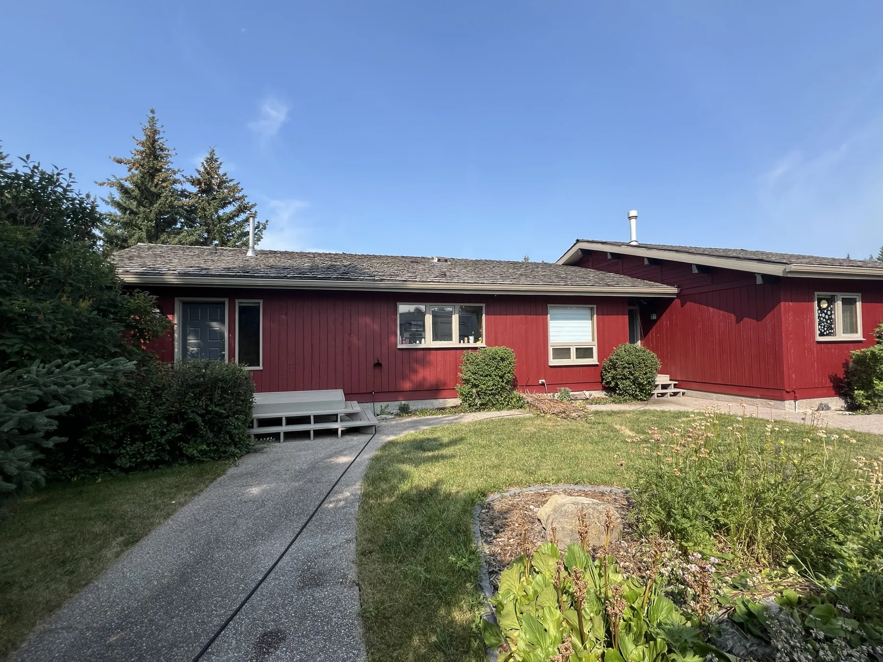 Finished red Calgary bungalow exterior professionally painted by Dynamic Painting