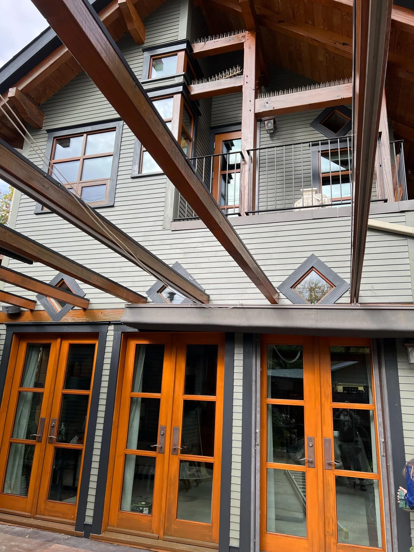 High-end exterior wood project with stained doors, beams and architectural trim