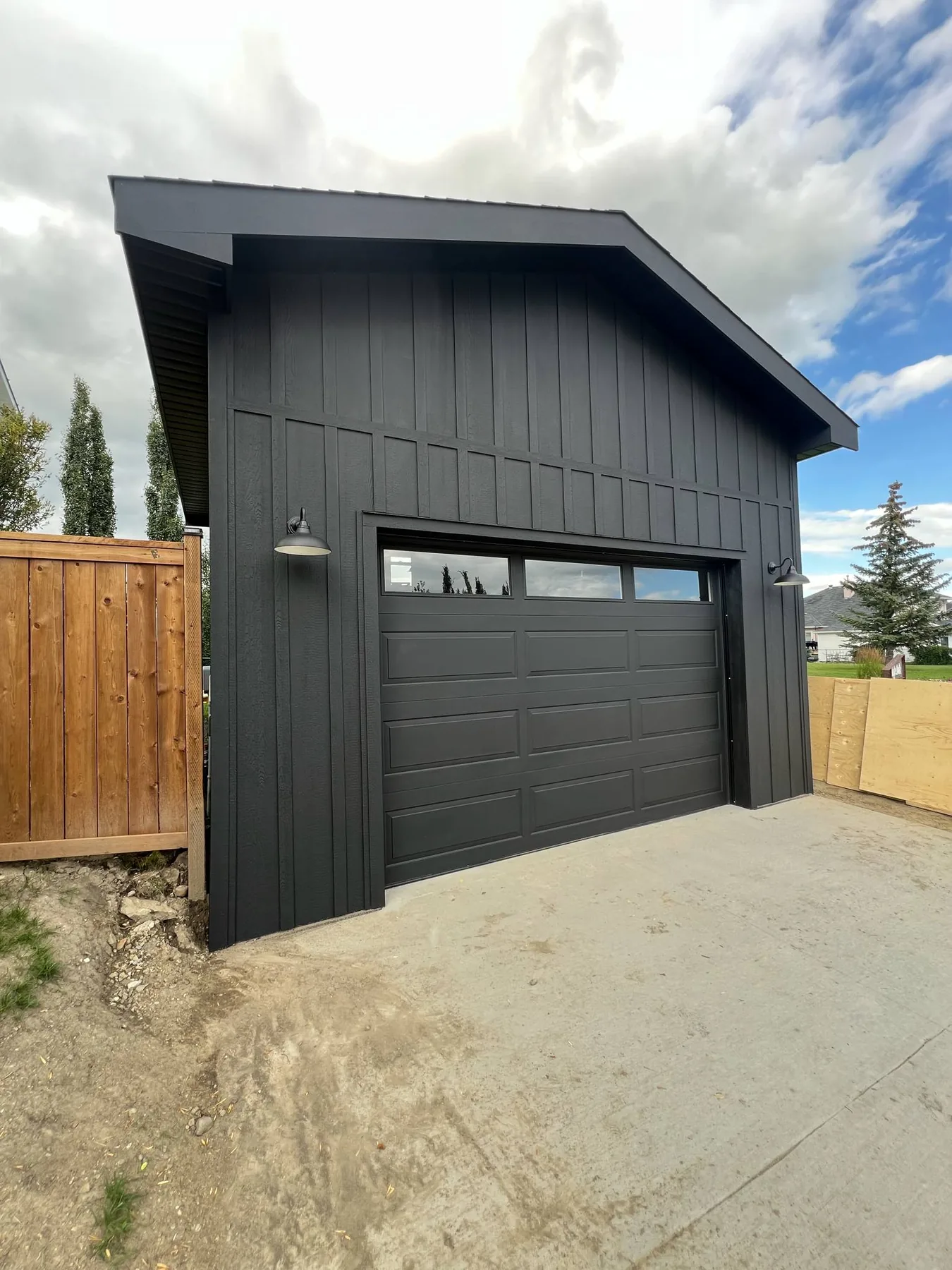 Black detached garage exterior and garage door professionally painted by Dynamic Painting