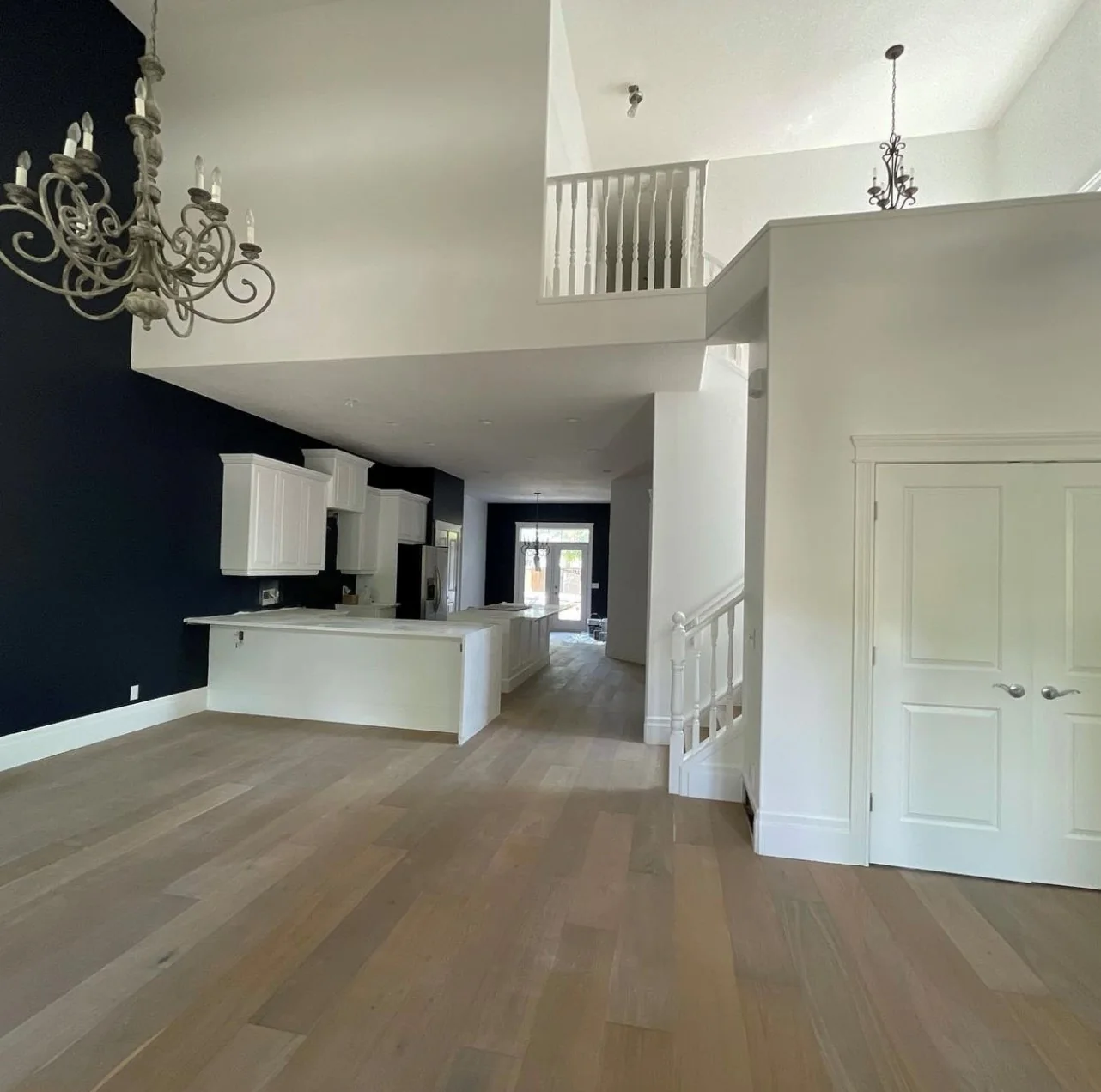 Dramatic dark feature walls with contrasting white trim in a high-ceiling Calgary interior