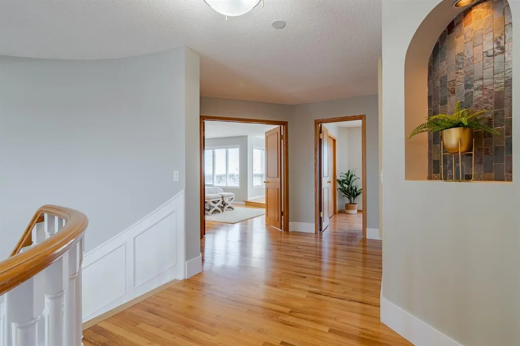 Upper hallway and landing in the same Calgary home showing clean wall and trim finishes