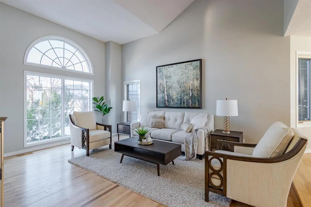 Bright staged Calgary living room with professionally painted walls and crisp white trim