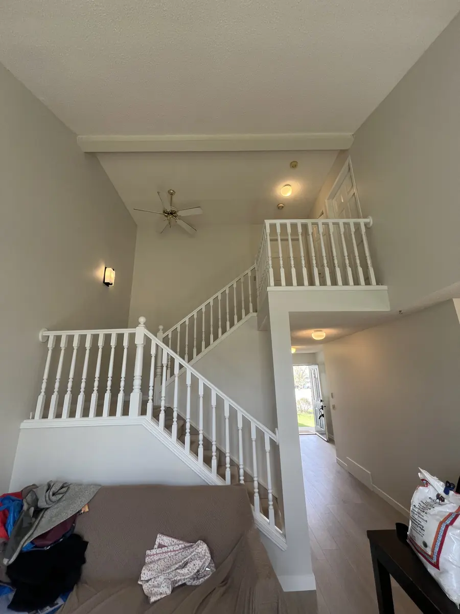 Bright painted Calgary staircase with crisp white railing and neutral walls
