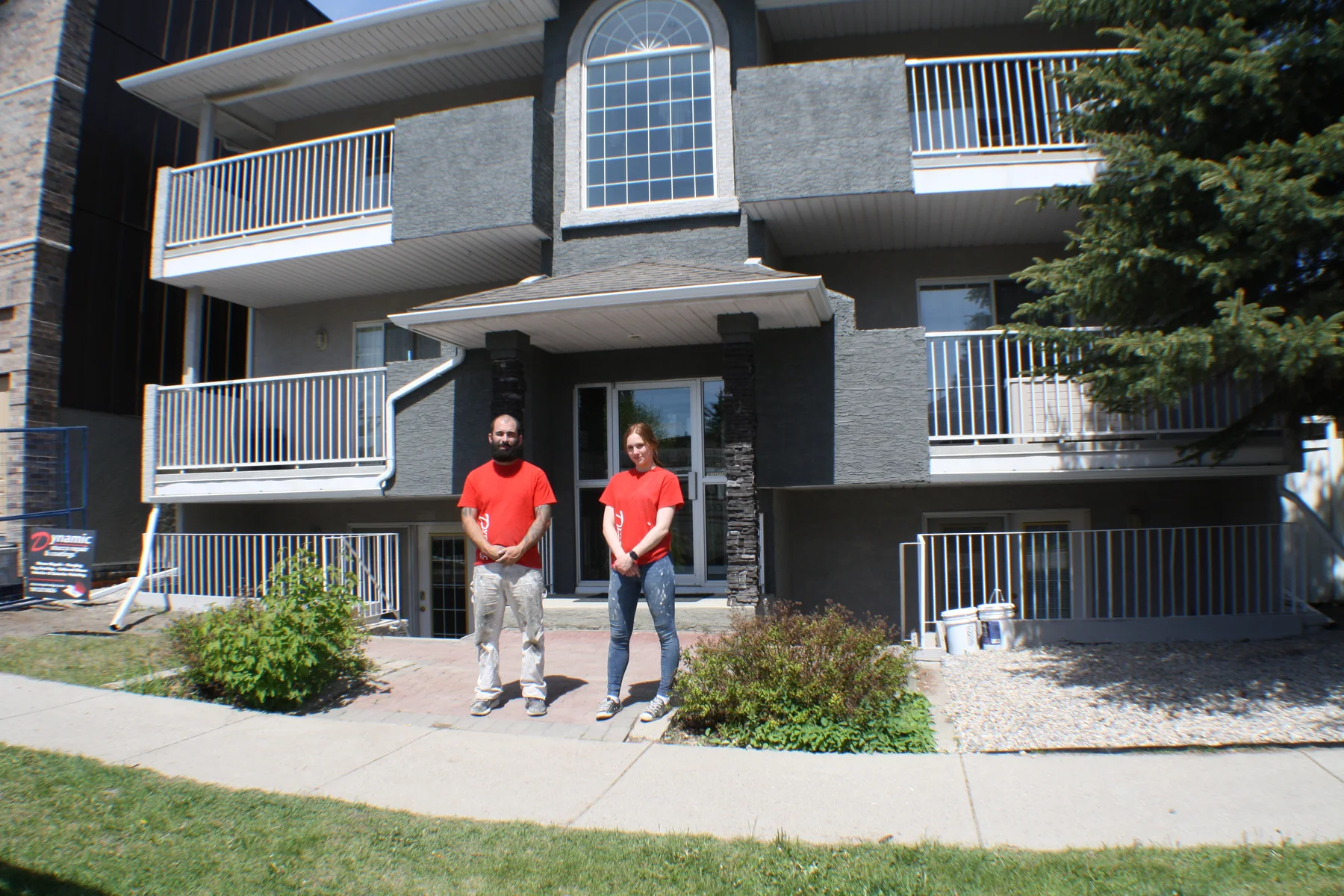 Dynamic Painting crew in front of a completed multi-unit stucco exterior painting project