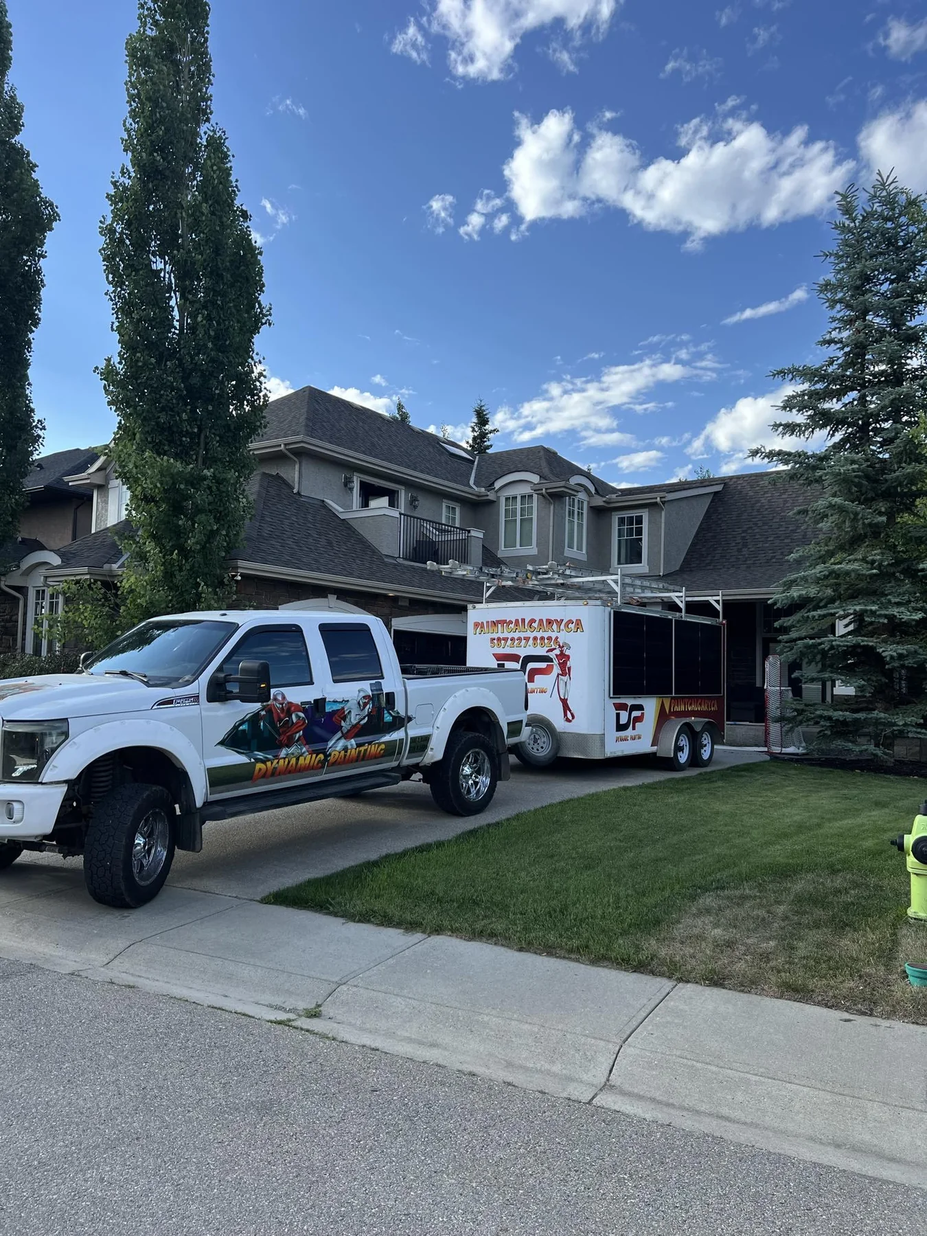 Dynamic Painting truck and trailer on site at a large completed Calgary stucco project