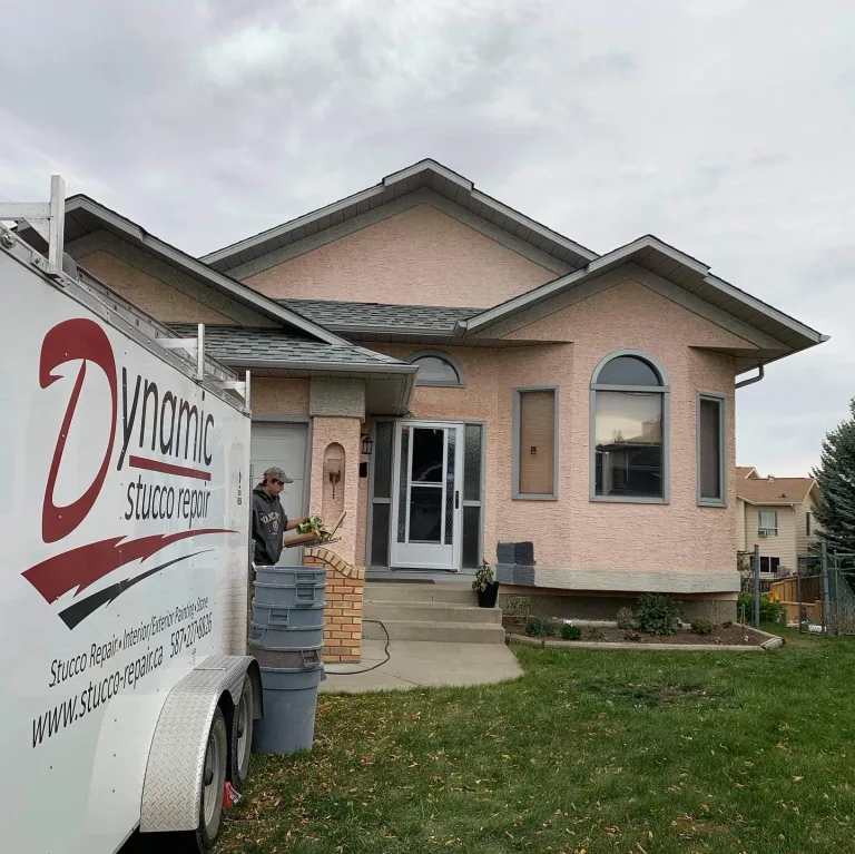 Peach stucco home before Dynamic Painting’s repair and repaint project