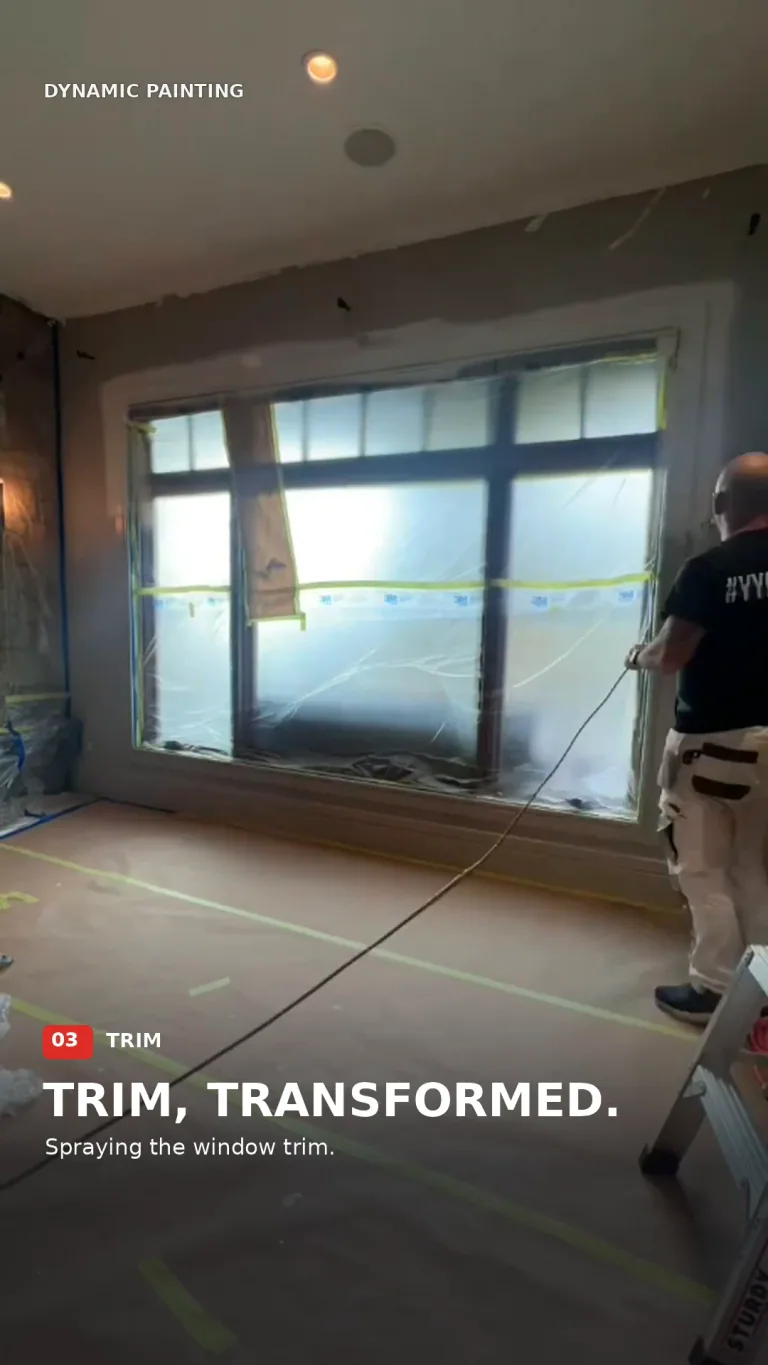 Painter spraying window trim in a protected main-floor room, shown in the preparation film