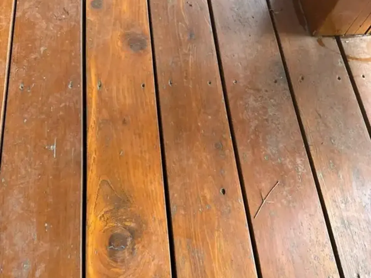 Weathered deck boards with worn finish before Dynamic Painting refinishing